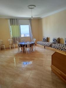 a living room with a table and a couch at Résidence Nydia in Ras El Ma +17 photos