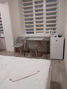 a bedroom with a table and a chair and a window at Hotel Avatar in Oleksandriya