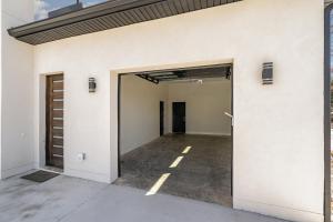 an open garage door of a white building at Phillips Apt in Matthews