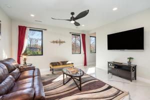 a living room with a couch and a flat screen tv at Phillips Apt in Matthews