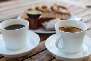 two cups of coffee and a plate of pretzels at Haraki Village in Haraki