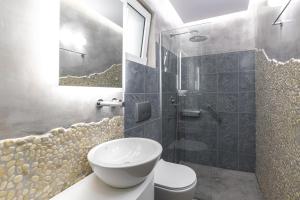 a bathroom with a sink and a toilet and a shower at Haraki Village in Haraki
