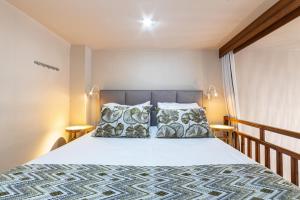 a bedroom with a bed with two pillows at Haraki Village in Haraki