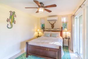 a bedroom with a bed and a ceiling fan at Blue Loon - Whole House in Belfast