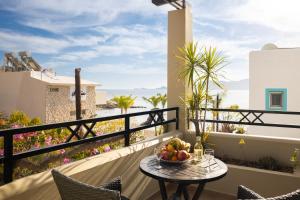 a table with a bowl of fruit on a balcony at Haraki Village in Haraki