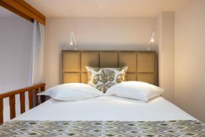 a bedroom with a bed with two pillows at Haraki Village in Haraki