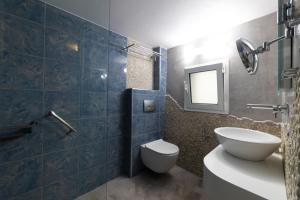 a bathroom with a toilet and a sink and a mirror at Haraki Village in Haraki