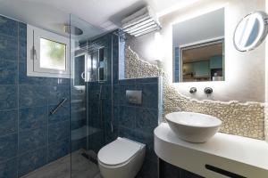 a bathroom with a toilet and a sink and a shower at Haraki Village in Haraki