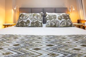 a bed with two pillows on top of it at Haraki Village in Haraki