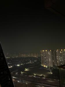 a view of a city at night with buildings at Highrise heaven and green garden patio in Ghaziabad +4 photos