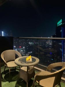 a table and chairs on a balcony with a view at Highrise heaven and green garden patio in Ghaziabad