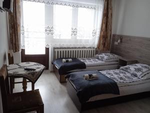Posteľ alebo postele v izbe v ubytovaní Pokoje Gościnne U Babuni