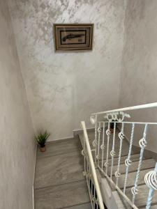 a stairway with a painting on the wall and a picture on the wall at Casa Dana in Iaşi