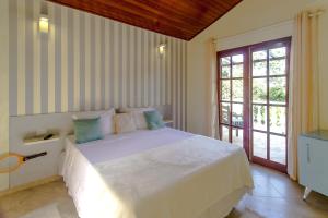 Un pat sau paturi într-o cameră la Pousada Villa Valentina