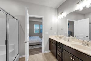 a bathroom with a double sink and a mirror at Peaceful 3BR near soccer park in Raleigh +22 photos
