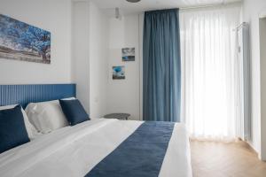 Postel nebo postele na pokoji v ubytování Hezio Guest House