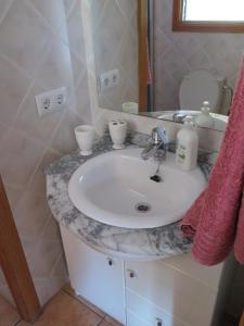 a bathroom with a white sink and a mirror at Ideal for resting, hiking or biking in Sóller