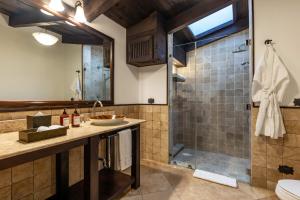 a bathroom with a sink and a shower at El Convento Boutique Hotel in Antigua Guatemala +58 photos