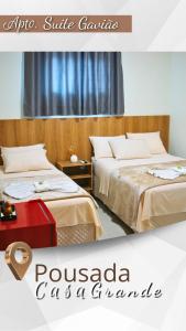two beds sitting next to each other in a room at Pousada Casa Grande in Barra do Garças