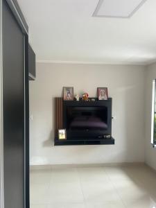 a living room with a flat screen tv on a wall at Comfortable home for COP-30 in Belém