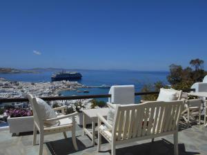 a balcony with chairs and a view of a harbor at La Veranda of Mykonos Traditional Guesthouse in Mýkonos City