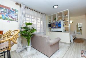 a living room with a couch and a potted plant at Polea Hapa in Ngong