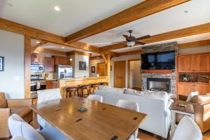 a living room with a table and a fireplace at Endless Grandfather View at Echota in Valle Crucis
