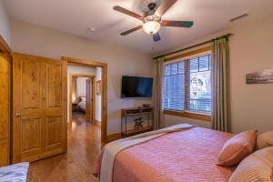 a bedroom with a bed and a ceiling fan at Endless Grandfather View at Echota in Valle Crucis +33 photos