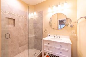 a bathroom with a shower and a sink and a mirror at Sweet Water Estate in Butler +52 photos