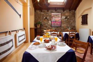 a dining room with a table with food on it at Hotel Rural Matsa in Lezama