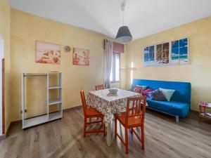 a living room with a table and a blue couch at House Rene in Agerola +49 photos