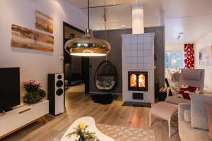 a living room with a couch and a fireplace at Villa It's Arctic Magic! in Rovaniemi