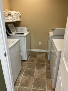 a small laundry room with a washer and dryer at Riverview Suites in Clarenville