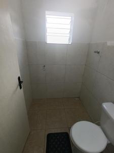 a small bathroom with a toilet and a window at Studio _ Santana de Parnaíba SP in Santana de Parnaíba