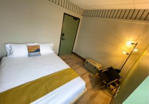 a bedroom with a bed and a lamp and a door at Zenith Basecamp in Duluth