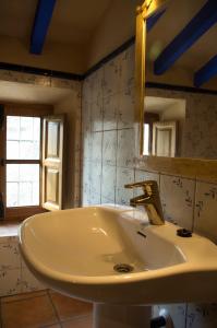 a bathroom with a sink and a mirror at Rural Montes Málaga: Cortijo La Palma in Málaga