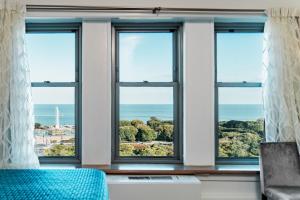 a room with four windows with a view of the ocean at Congress Plaza Hotel Chicago in Chicago