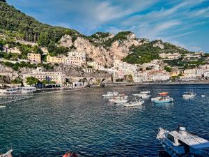 a group of boats in a body of water at House Rene in Agerola