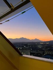 a view of a city from a window with the sunset at La Casetta Dei Pescatori in Montesilvano