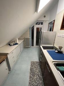 a kitchen with white counters and a staircase in a room at La Casetta Dei Pescatori in Montesilvano