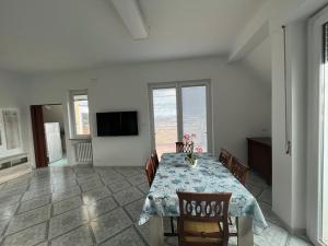 a dining room with a table and chairs and a television at La Casetta Dei Pescatori in Montesilvano