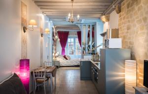 a kitchen and a living room with a refrigerator at Le Nid De La Loire in Blois