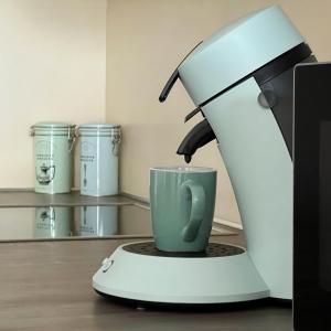 a coffee machine with a green coffee cup at Duinhelm Vakantiestudio Mariakerke - A cosy place by the sea in Ostend