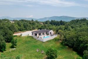 an aerial view of a house with a swimming pool at Villa Anthea and Paola in Nedeščina