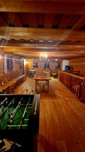 a large room with a pool table and chairs at Sonnleit'n Zimmer 7 in Abtenau