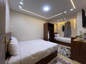 a bedroom with two beds and a television in it at Isis Pyramids View Inn in Cairo