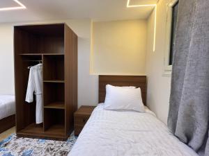 a small bedroom with a bed and a closet at Isis Pyramids View Inn in Cairo