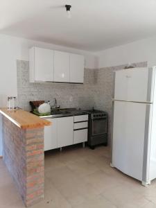 a kitchen with white appliances and a white refrigerator at Verde in Cuchilla Alta