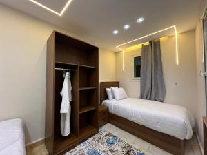 a bedroom with two beds and a closet at Isis Pyramids View Inn in Cairo