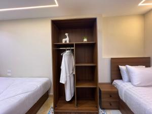 a bedroom with two beds and a book shelf at Isis Pyramids View Inn in Cairo